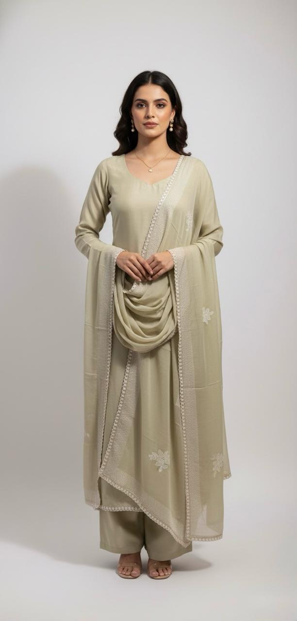 Muslin suit with intricate machine embroidery, paired with a muslin dupatta featuring delicate thread work lace — elegant and graceful.